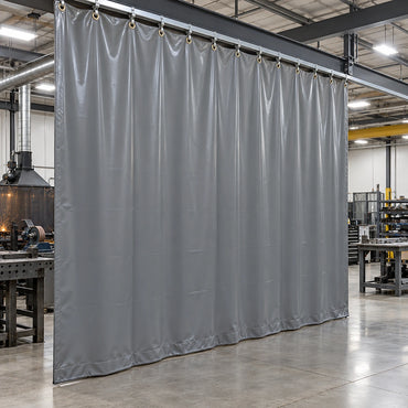 Custom gray vinyl shop curtain dividing work areas in a metal fabrication shop