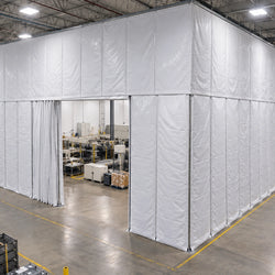 Custom three-sided insulated curtain wall enclosure around production area in manufacturing facility