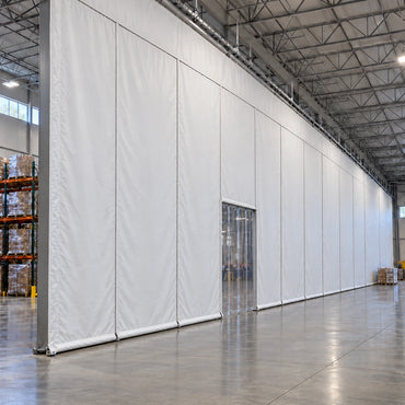 Custom insulated warehouse curtain walls installed in industrial facility with equipment and storage visible