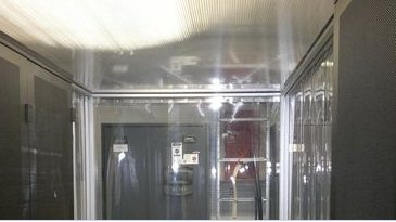 Anti-static strip door curtains at data center entrance, static dissipative PVC for sensitive equipment protection