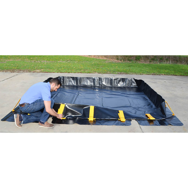 Stinger spill berm setting up for containing drums on job site