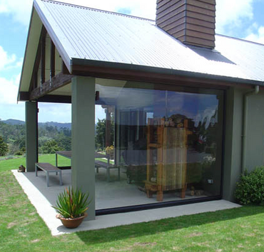 Patio or porch installation Custom clear vinyl tarp installed on outdoor patio enclosure with grommets 